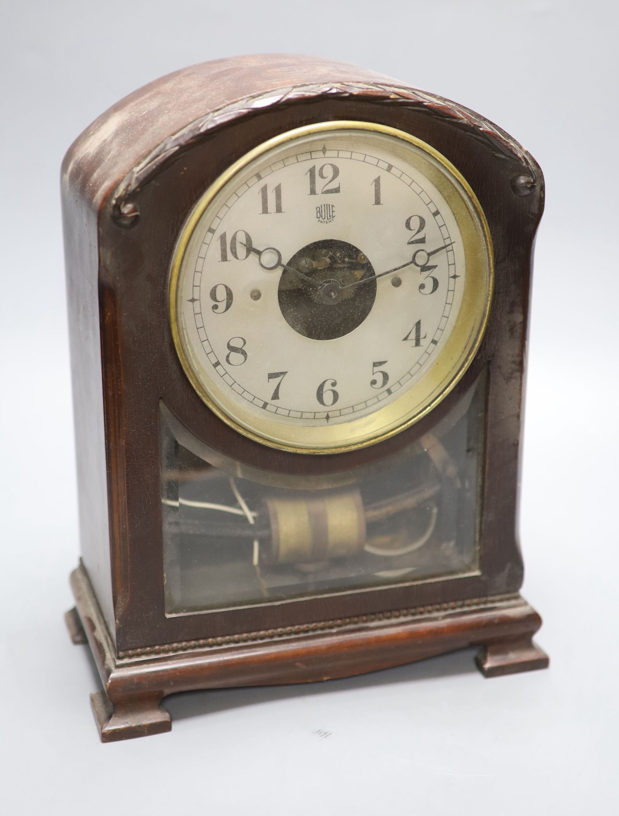 A Bulle mahogany mantel clock, with laurel wreath carving to the arched top, height 32cm